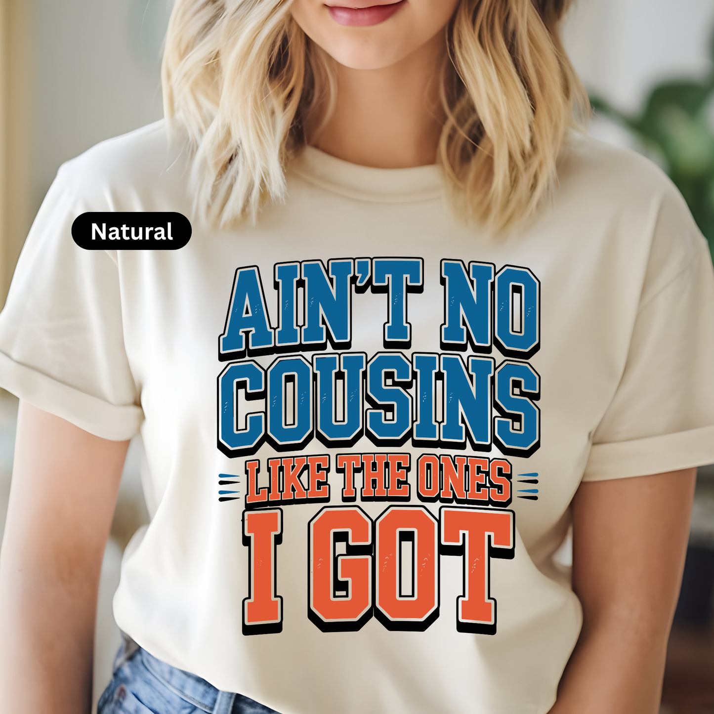 Person wearing a white t-shirt with colorful text design.