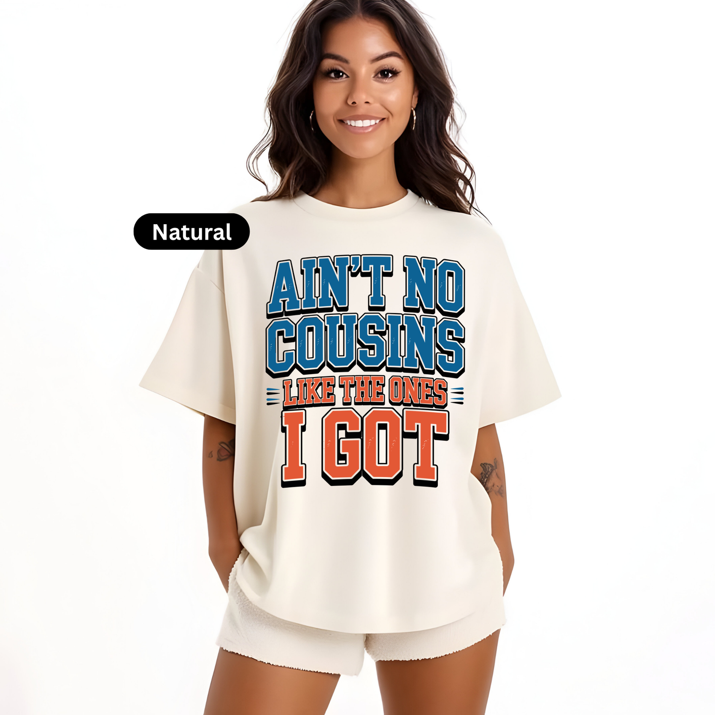 Woman wearing a cream-colored t-shirt with colorful text design on a white background