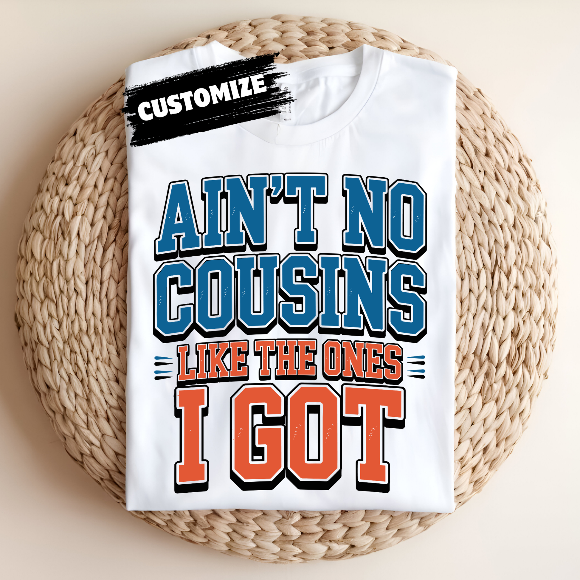 White t-shirt with colorful text design on a woven surface