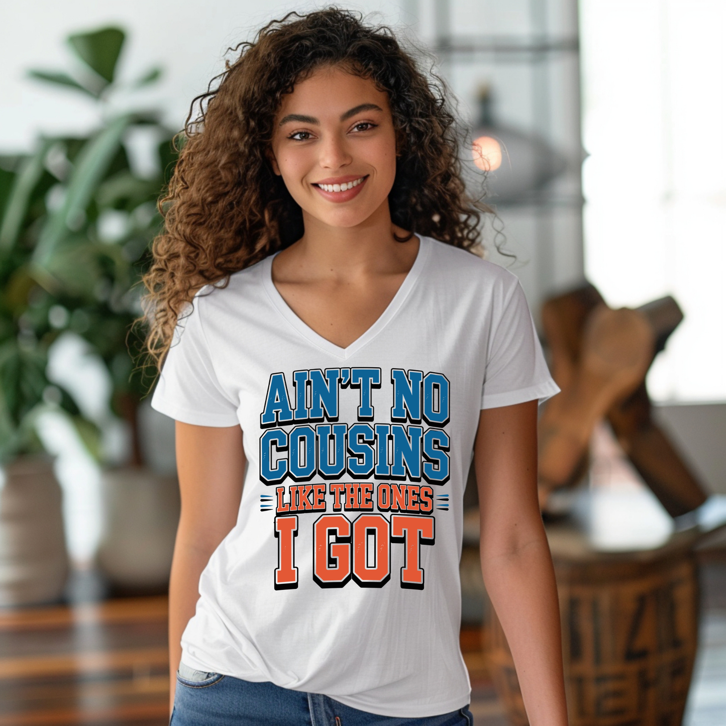 Woman wearing a white t-shirt with a colorful graphic design in an indoor setting.
