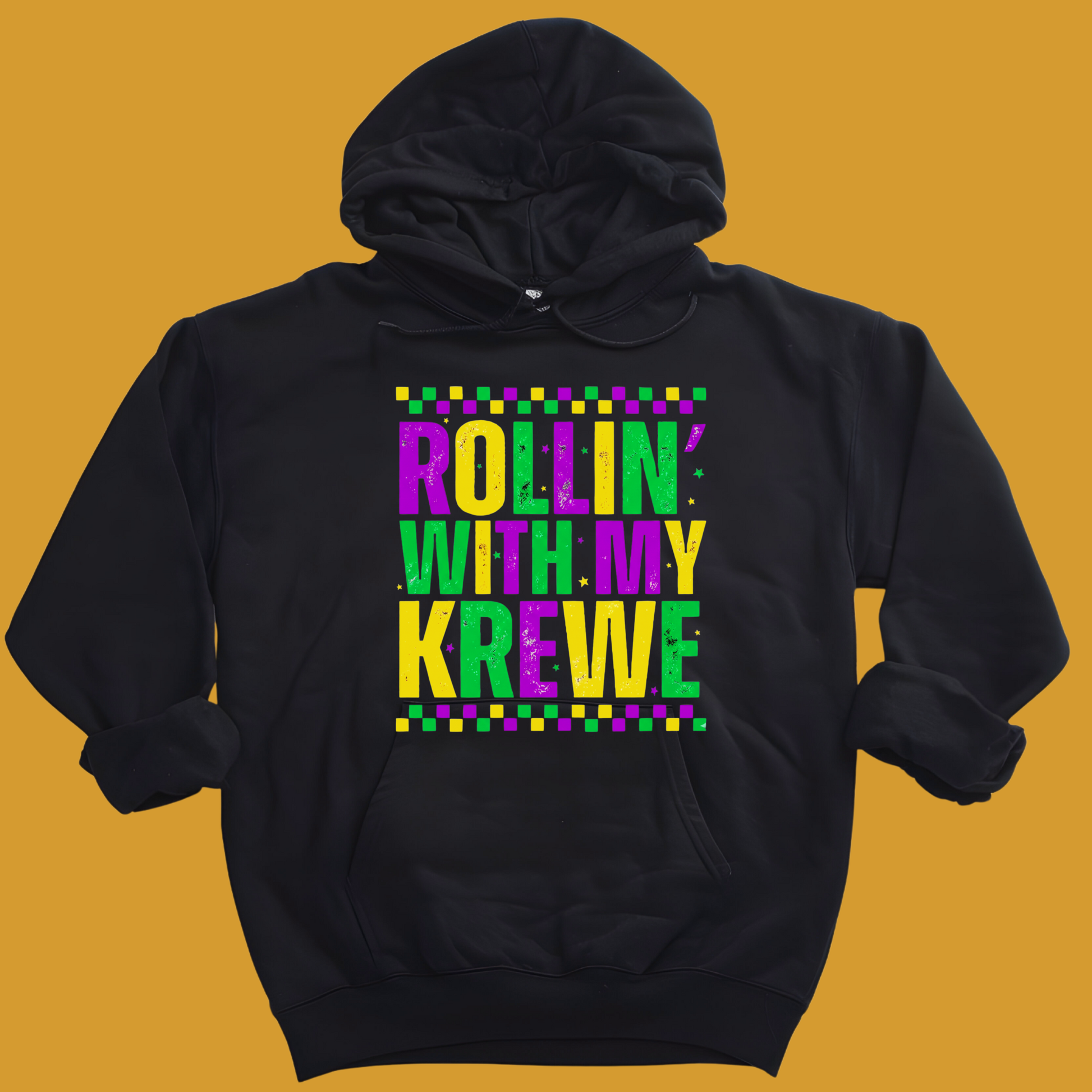 Black hoodie with colorful text 'Rollin with my Krewe' on a mustard yellow background