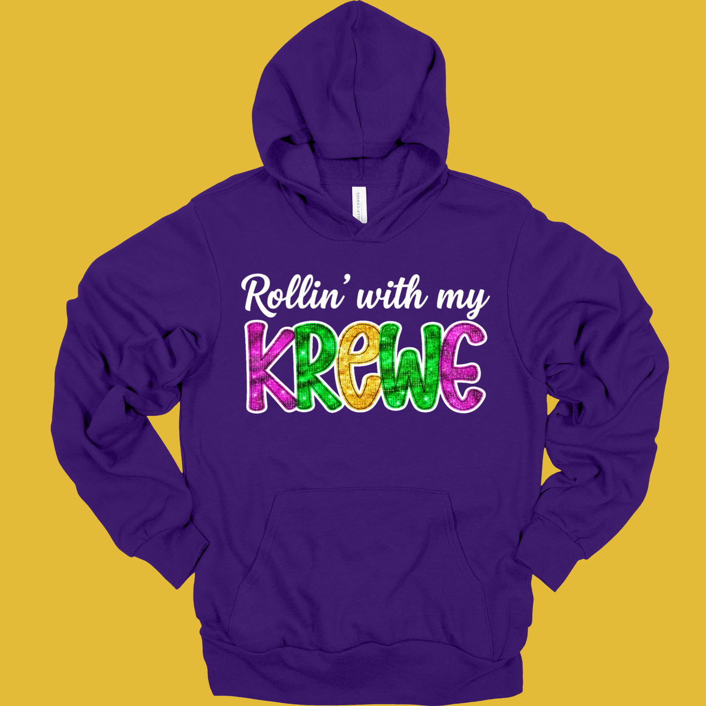 Purple hoodie with colorful text 'Rollin' with my Krewe' on a yellow background