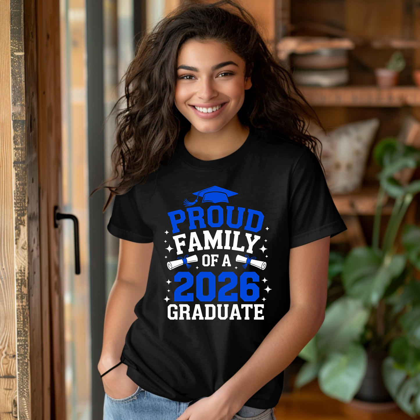 Person wearing a black t-shirt with 'Proud Family of a 2026 Graduate' text.