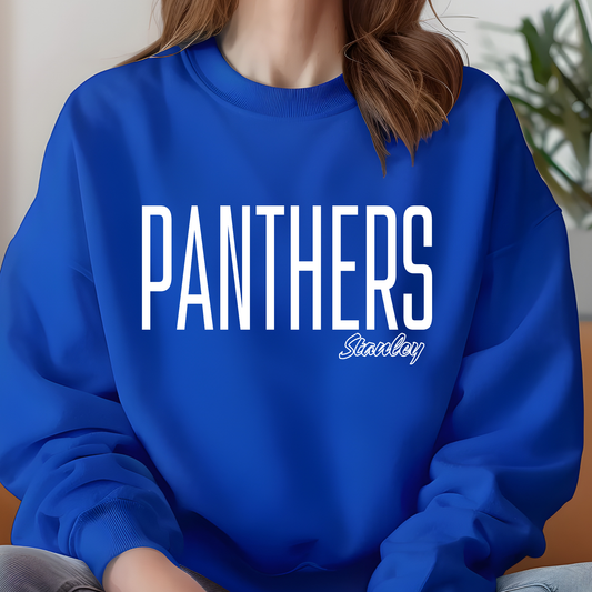 A person wearing a bright royal blue crewneck sweatshirt with 'PANTHERS' printed in large white letters and 'Stanley' in smaller script below, shown in a close-up lifestyle shot.