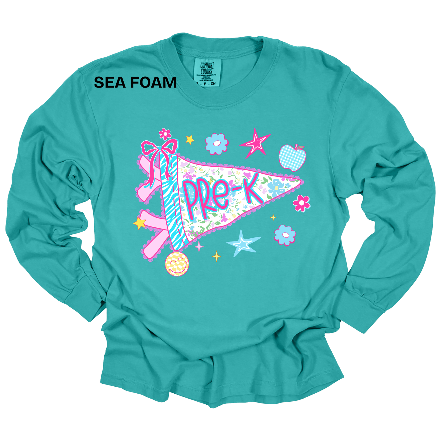 A turquoise long-sleeve t-shirt with a colorful 'Pre-K' pennant graphic on the front, featuring a ribbon, stars, and flowers. The text 'SEA FOAM' is printed in black near the upper left chest.