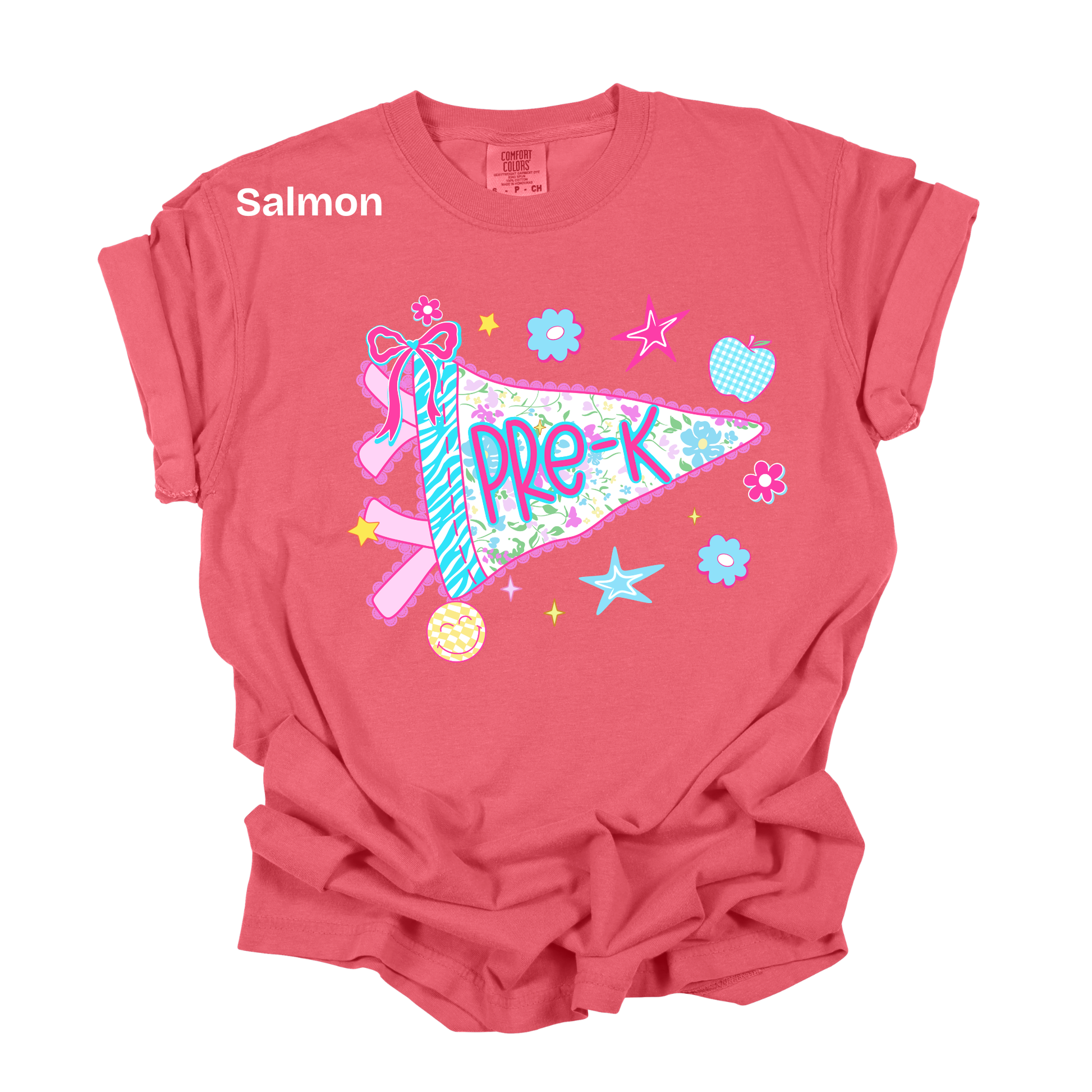 A salmon pink short-sleeve t-shirt with a colorful graphic on the front featuring a ribbon, flowers, stars, and a pennant that reads 'PRE-K'. The word 'Salmon' is printed in white on the upper left chest.