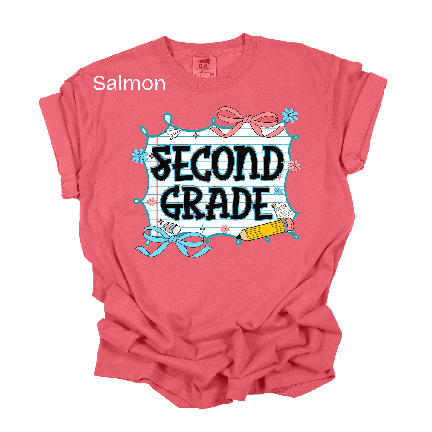A salmon pink short-sleeve t-shirt with a 'SECOND GRADE' school-themed graphic on the front, featuring a blue and white grid frame, pink bows, and a yellow pencil. The word 'Salmon' is printed in white text near the upper left chest.