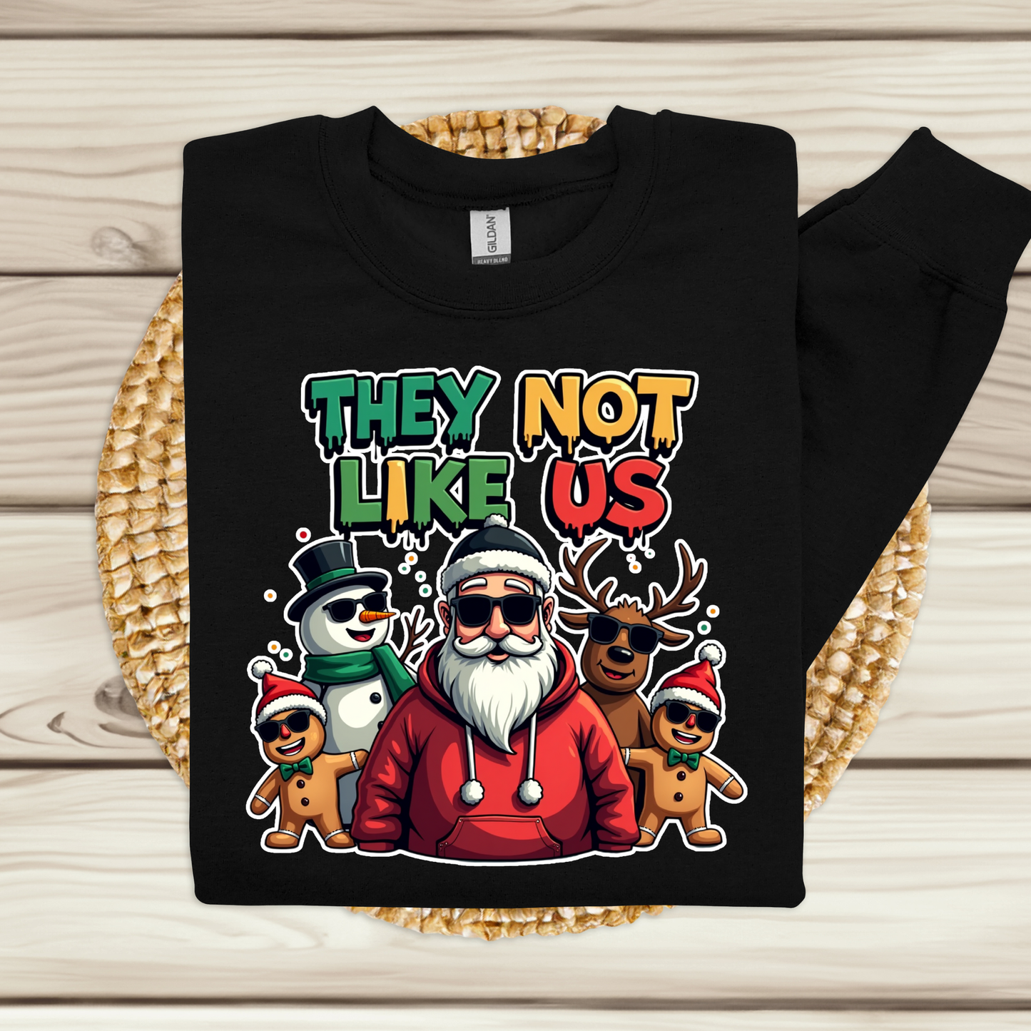 Black sweatshirt with a colorful graphic of Santa Claus and reindeer on a wooden surface