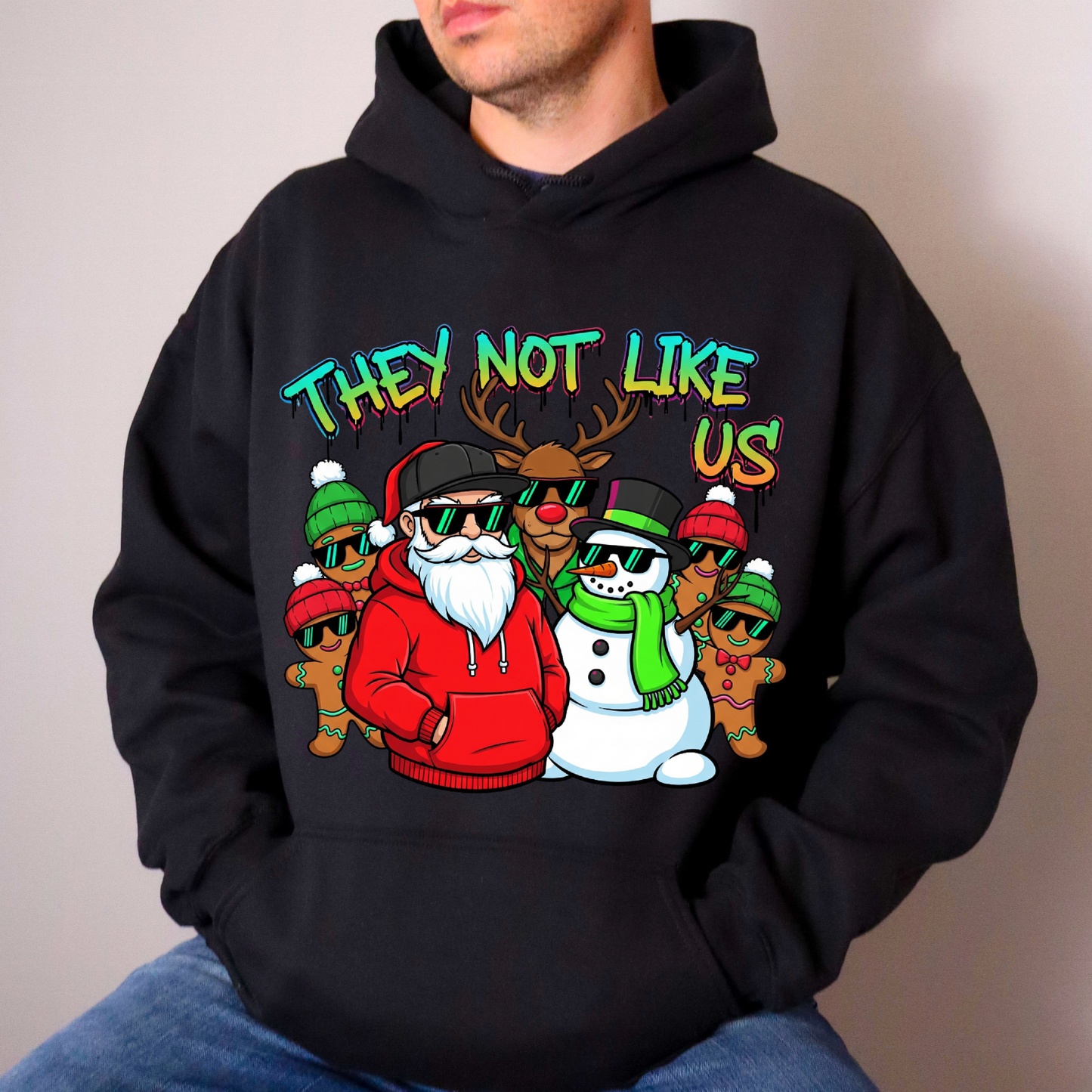 Person wearing a black hoodie with a colorful graphic design featuring Santa Claus and other characters.
