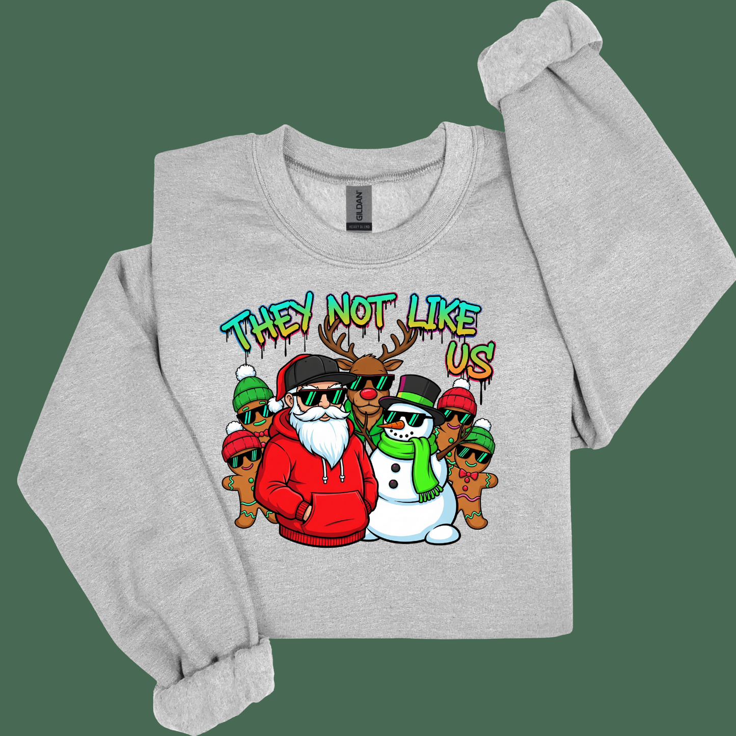 Gray sweatshirt with a colorful graphic of a reindeer, snowman, and other characters with text 'THEY NOT LIKE US' on a green background.