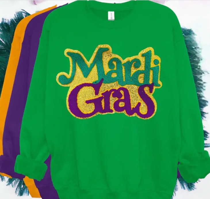 Green sweatshirt with 'Mardi Gras' text in gold, purple, and green on a colorful background.