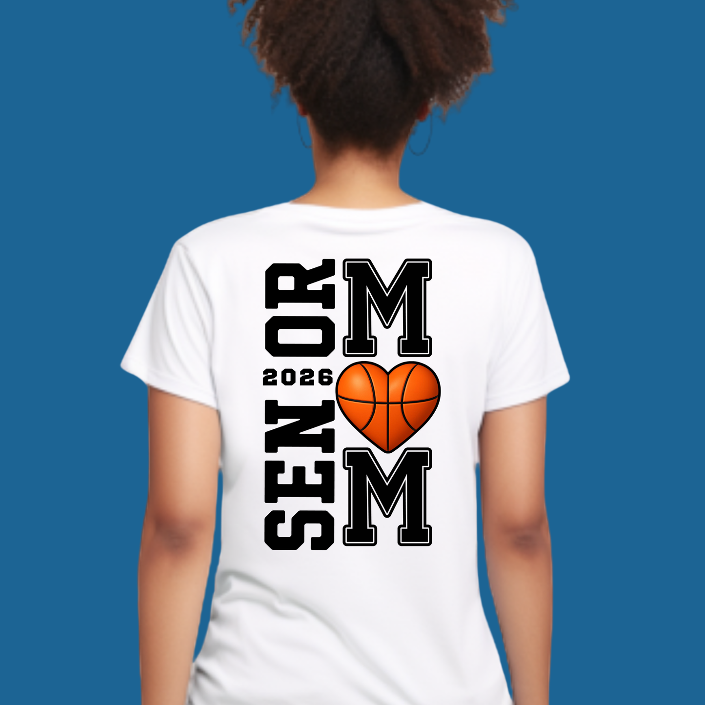 Person wearing a white t-shirt with 'Senior 2026' and heart-shaped basketball design on the back against a blue background.