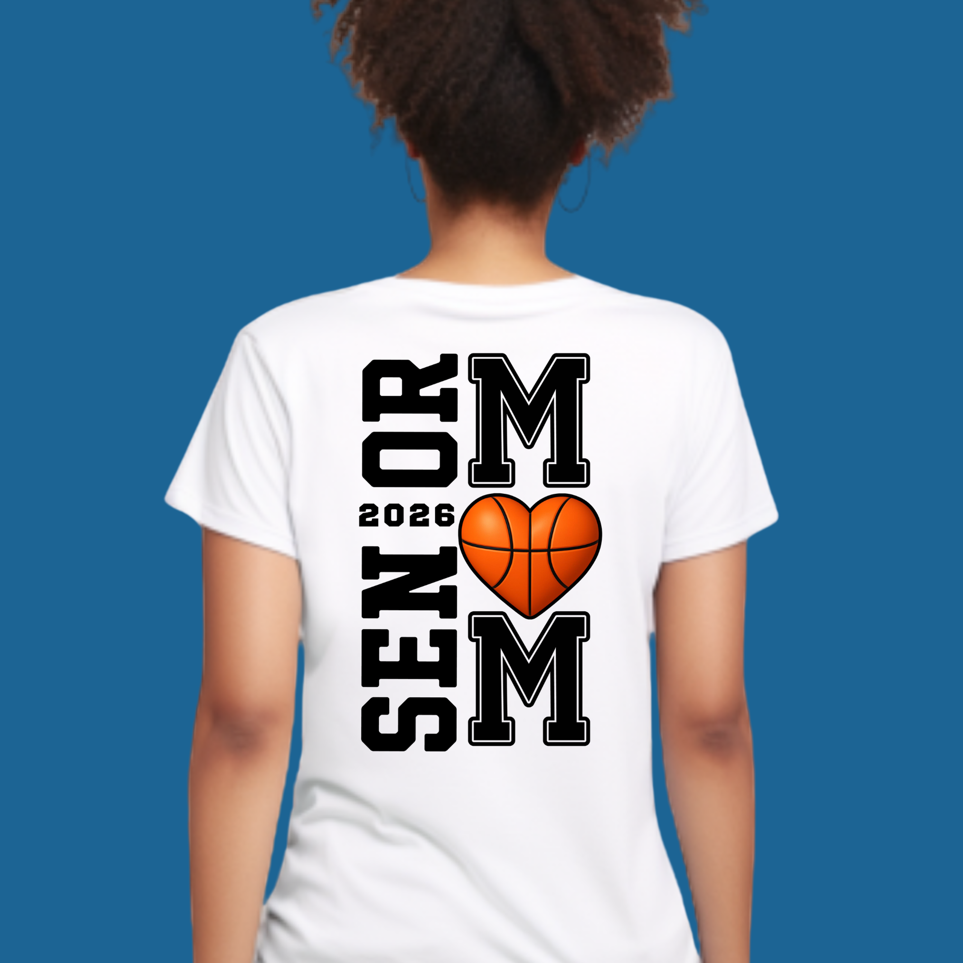 Person wearing a white t-shirt with 'Senior 2026' and heart-shaped basketball design on the back against a blue background.