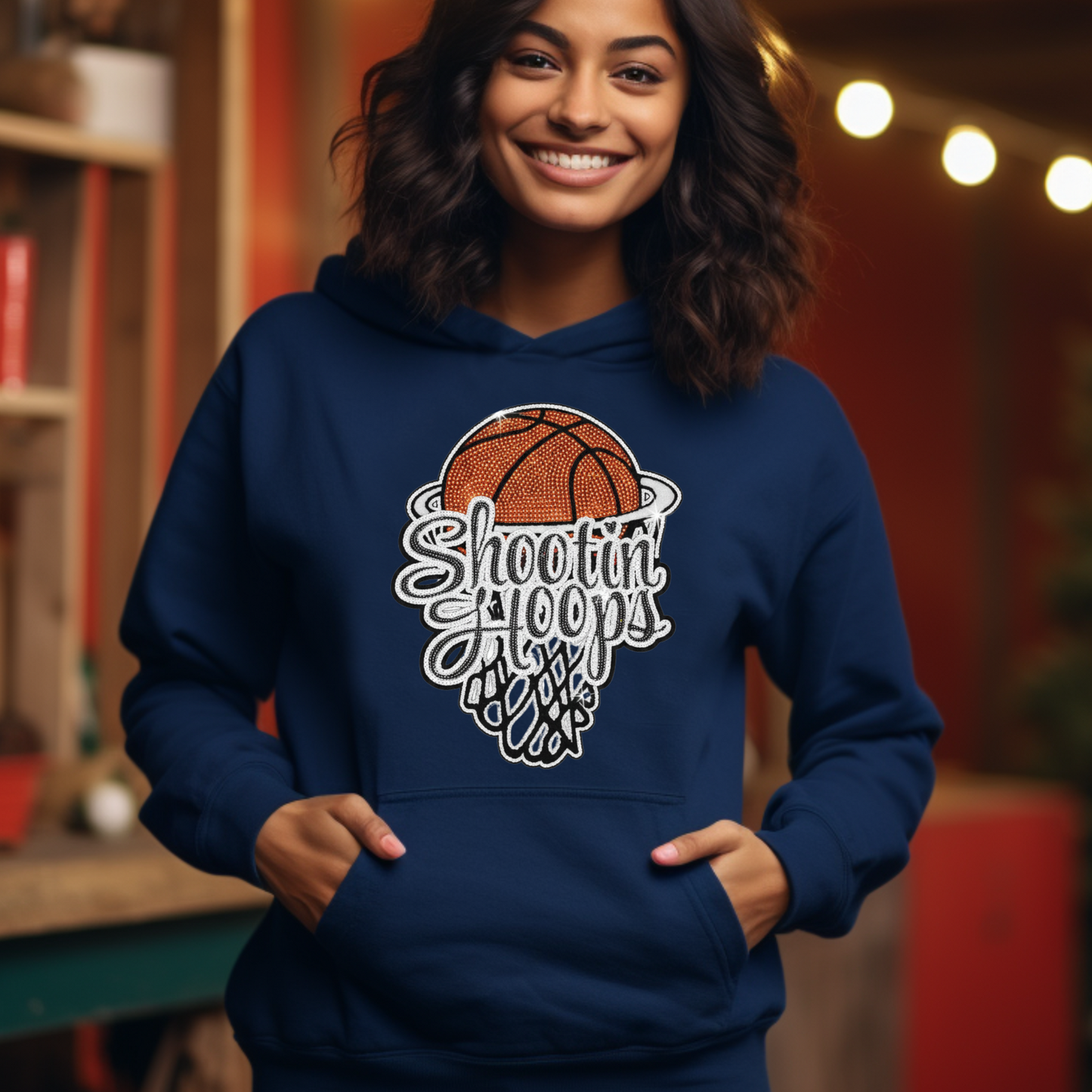 Person wearing a blue hoodie with a basketball design and text, standing in a casual indoor setting.