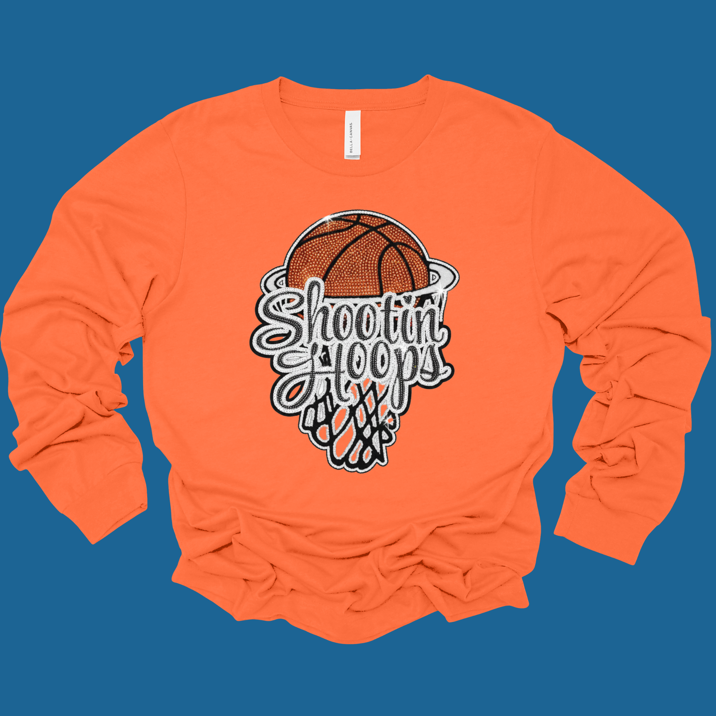 Orange long-sleeve shirt with 'Shooting Hoops' graphic on a blue background