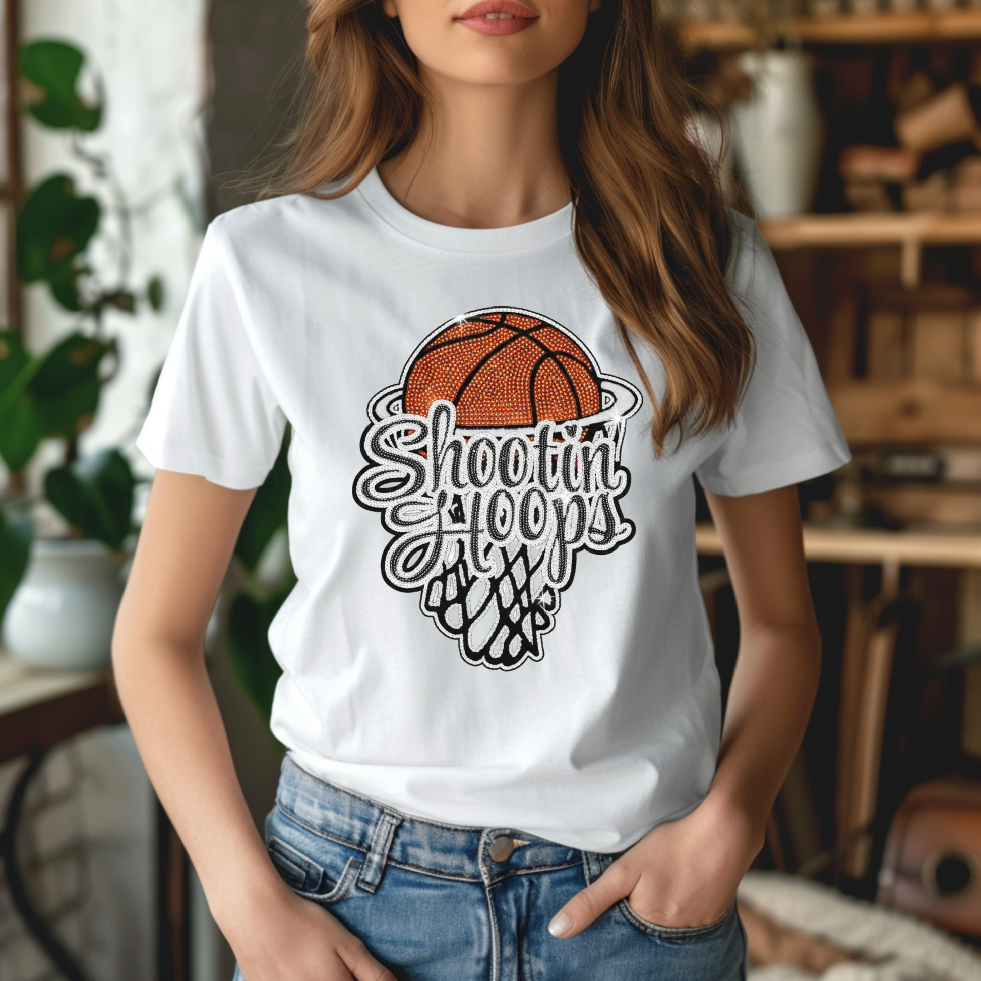 Person wearing a white t-shirt with a basketball graphic and text in a casual setting