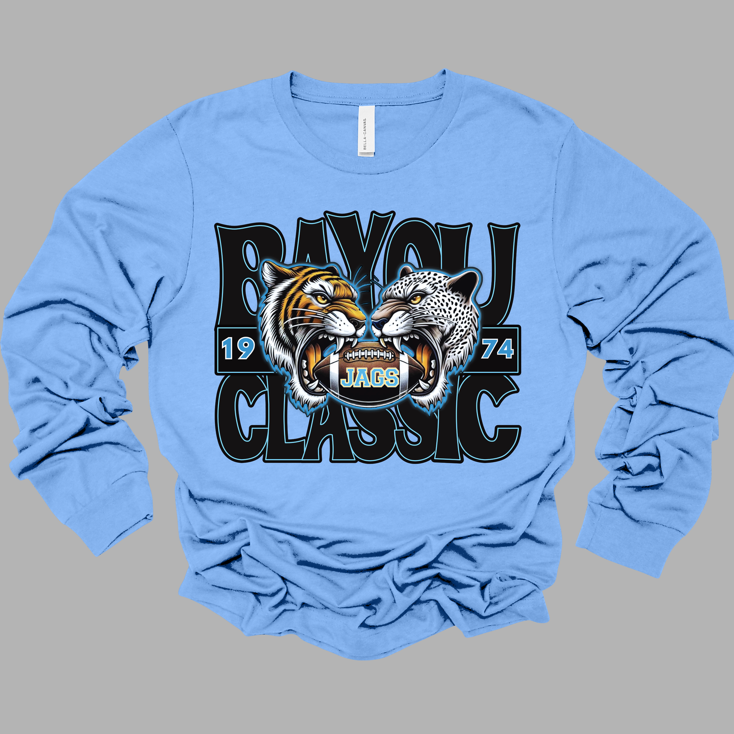 Light blue long-sleeve shirt with a graphic design of two roaring animals and text on a gray background