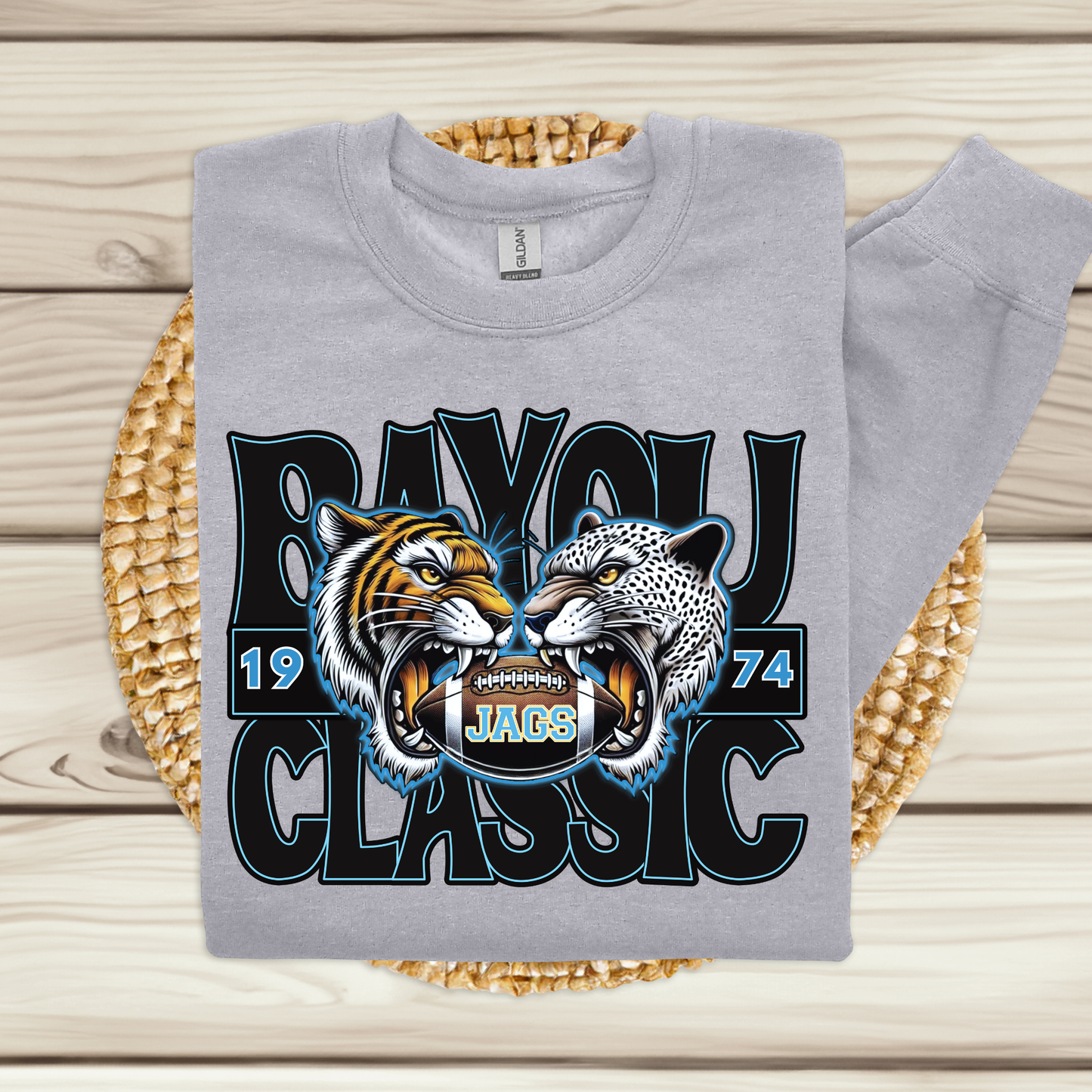Gray sweatshirt with tiger and jaguar design on a woven mat