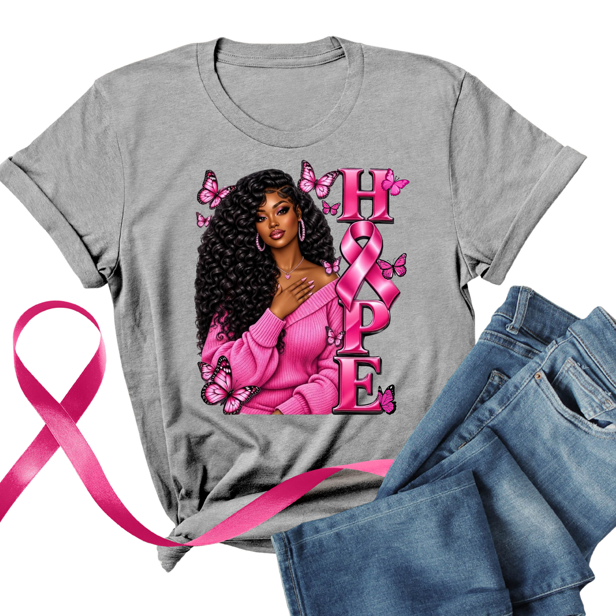 A heather gray short-sleeve T-shirt with a pink graphic reading 'I AM A SURVIVOR' surrounded by butterflies, pink ribbons, and hearts, styled flat with blue jeans and a pink ribbon on a white background.