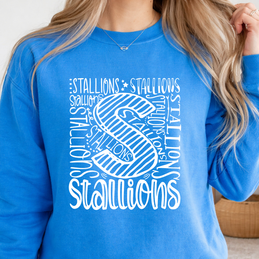 A woman wearing a bright blue crewneck sweatshirt with a large white graphic print on the front featuring the word 'STALLIONS' and a stylized letter 'S'.