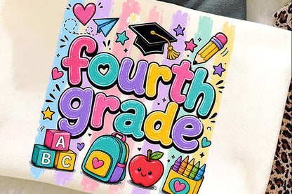 A white canvas tote bag featuring a colorful 'Fourth Grade' graphic print with school-themed illustrations like a graduation cap, pencil, backpack, apple, and blocks, laid flat on a soft surface.