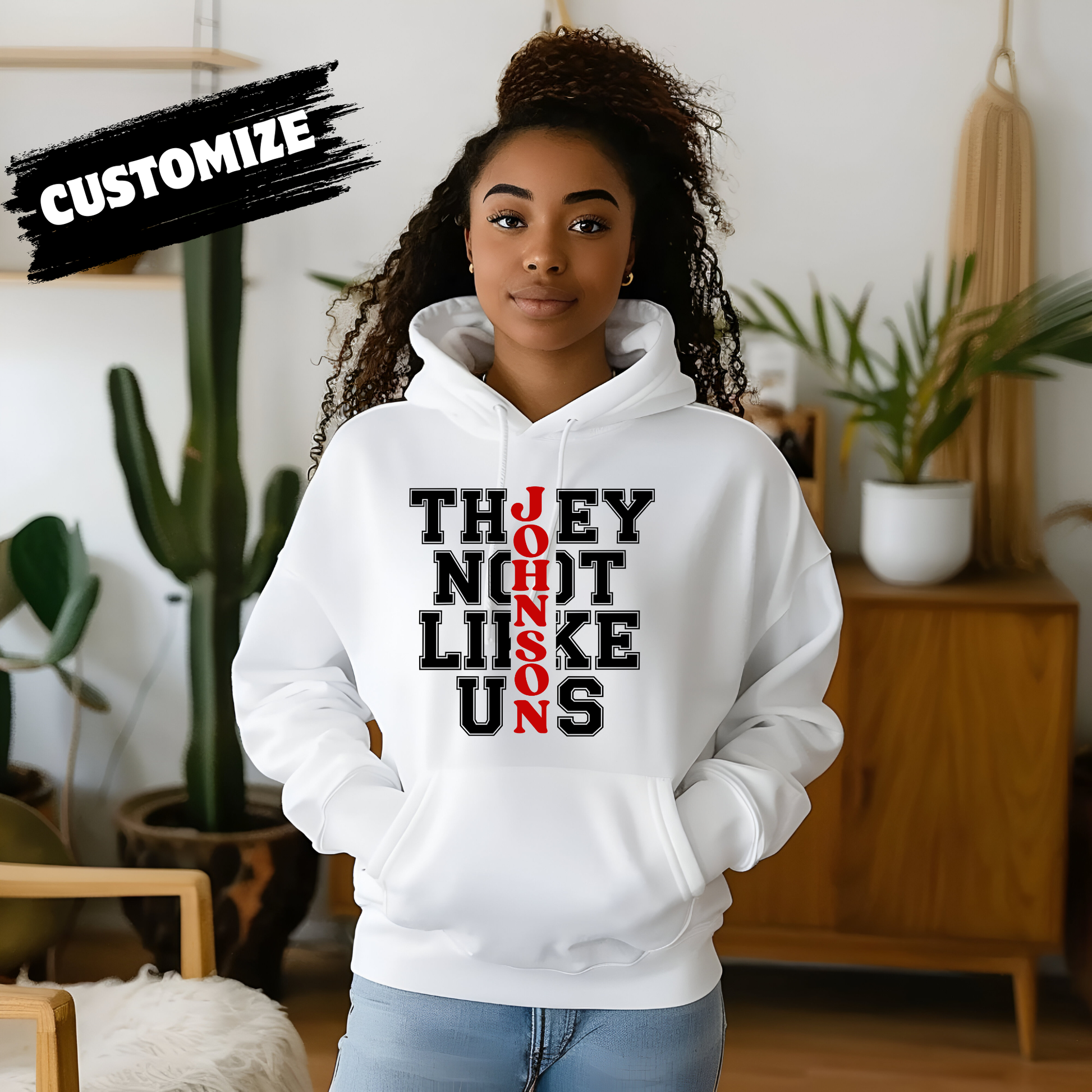 Person wearing a white hoodie with text in a room with plants Family Reunion Hoodie - They Not Like Us - Custom Family Name Matching Hoodie
