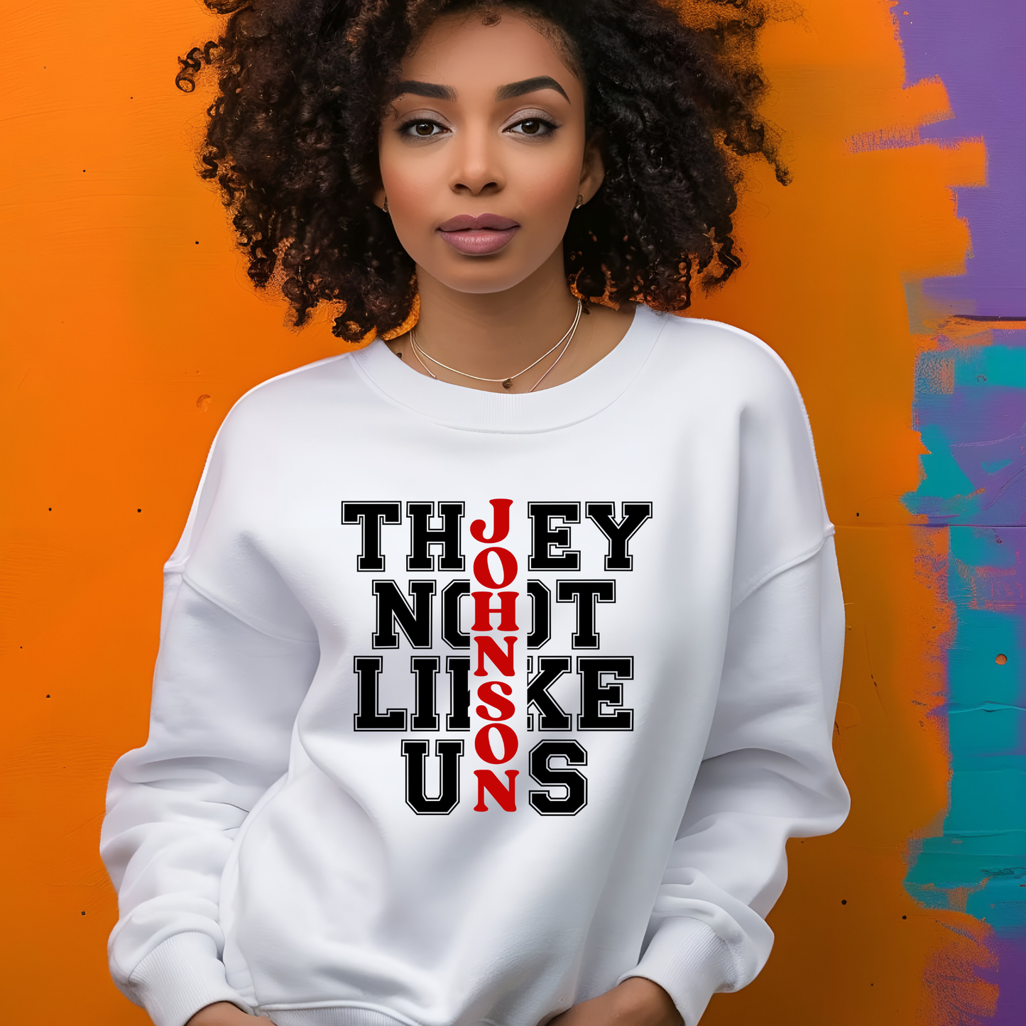 Woman wearing a white sweatshirt with text design against an orange and purple background
