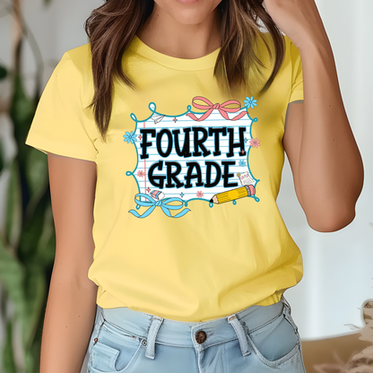 A woman wearing a bright yellow graphic t-shirt that reads 'FOURTH GRADE' in black letters inside a decorated blue and pink frame, paired with light blue jeans.