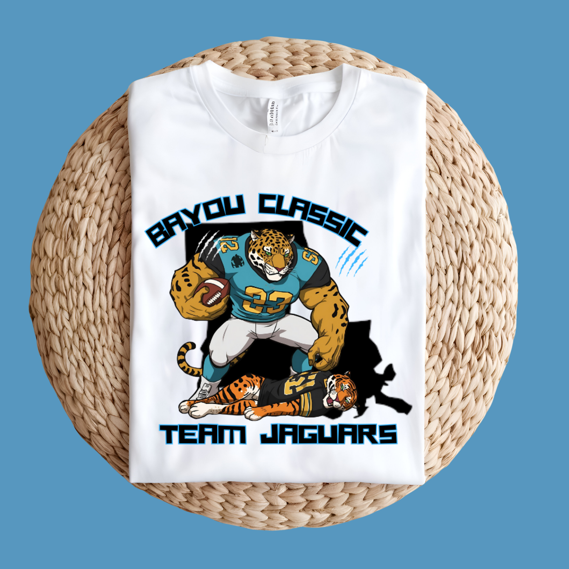 White t-shirt with 'BAYOU CLASSIC TEAM JAGUARS' design featuring a football player and jaguar graphics on a woven surface.  Bayou Classic Team Jaguars: Bayou Classic Team Jaguars Game Day T-Shirt