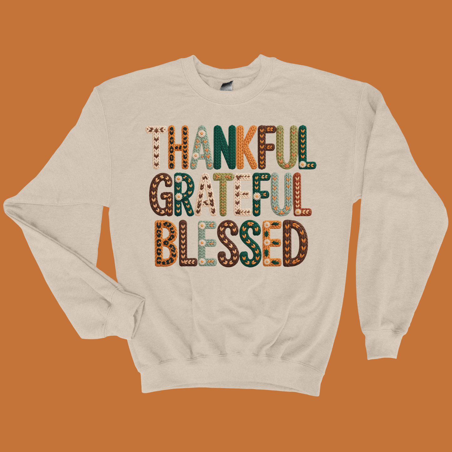 Beige sweatshirt with 'Thankful Grateful Blessed' text on an orange background