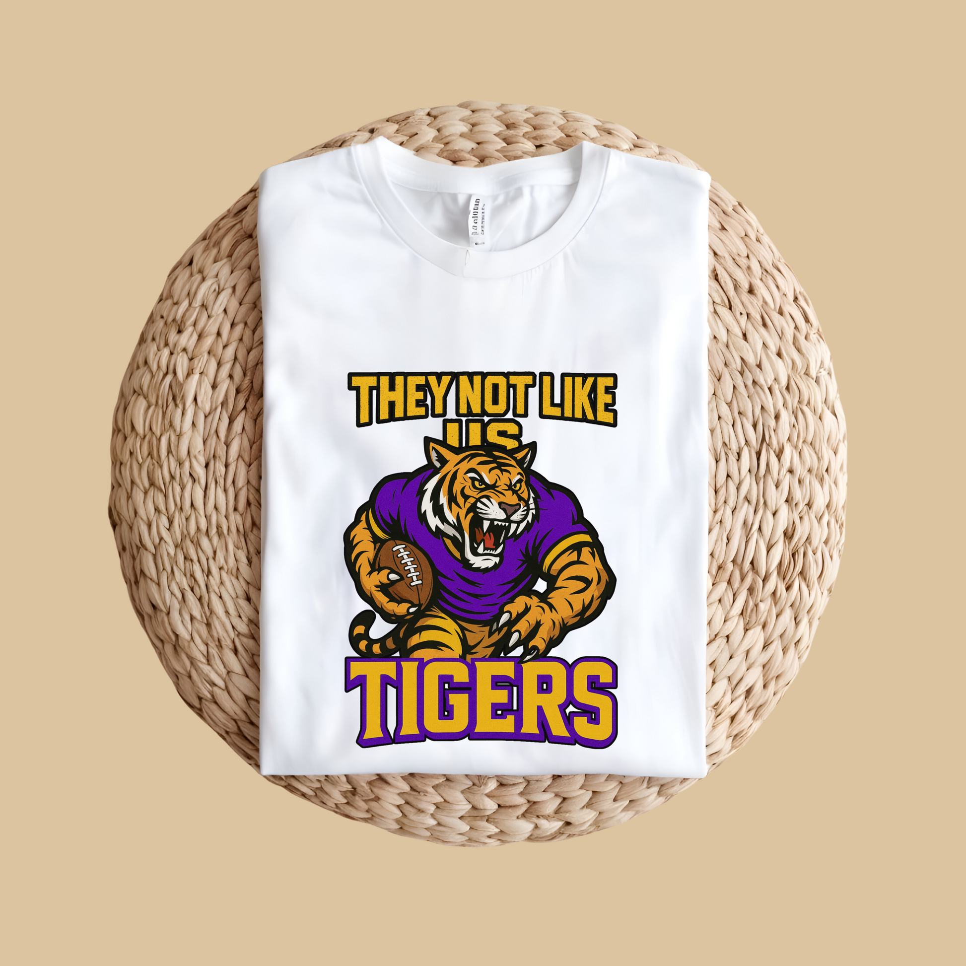 White t-shirt with a tiger graphic and text on a woven surface Tigers Mascot Shirt - Bold Tigers They Not Like Us Game Day Spirit Tee