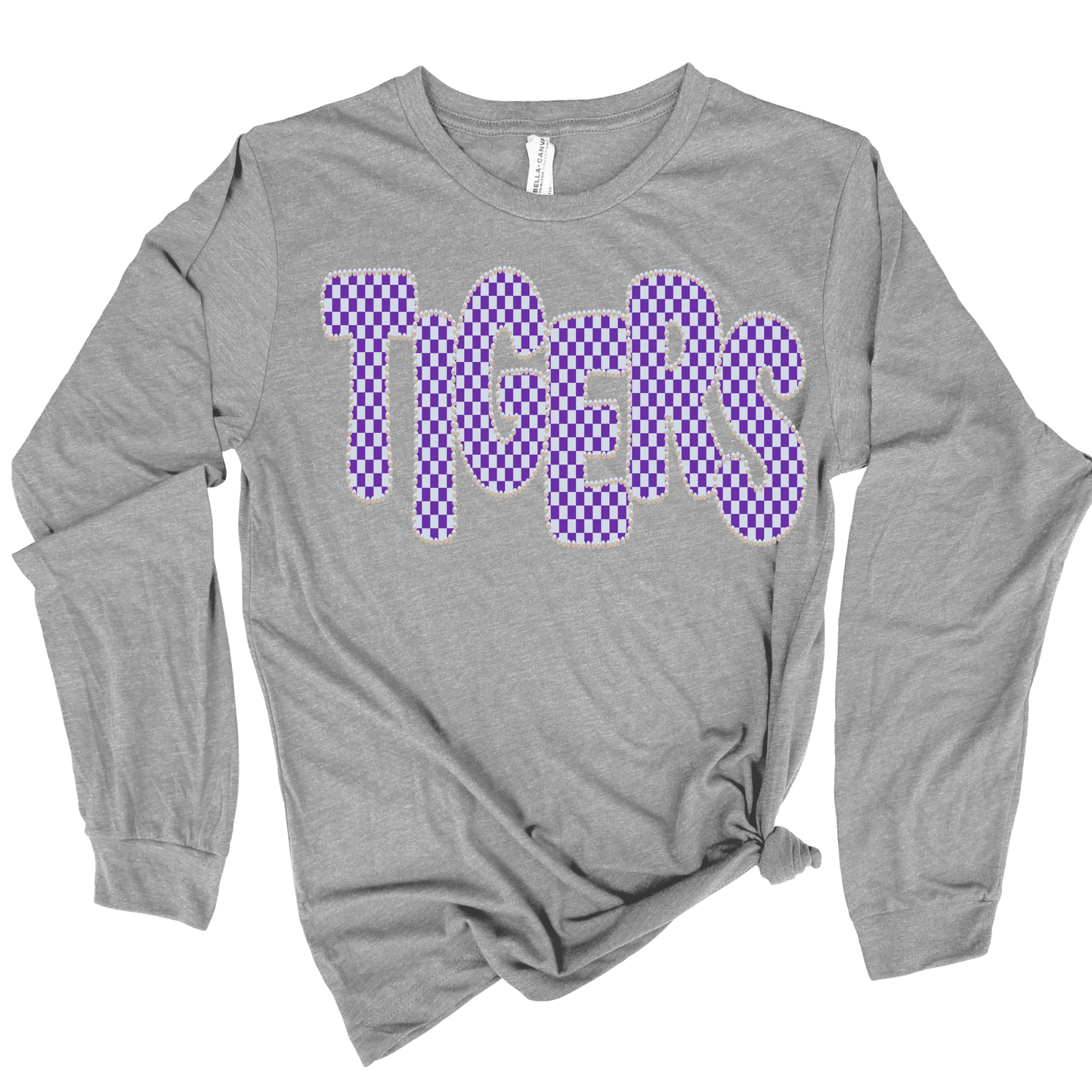 A heather gray long-sleeve t-shirt with 'TIGERS' printed across the chest in a purple and lavender checkerboard pattern with a white outline.