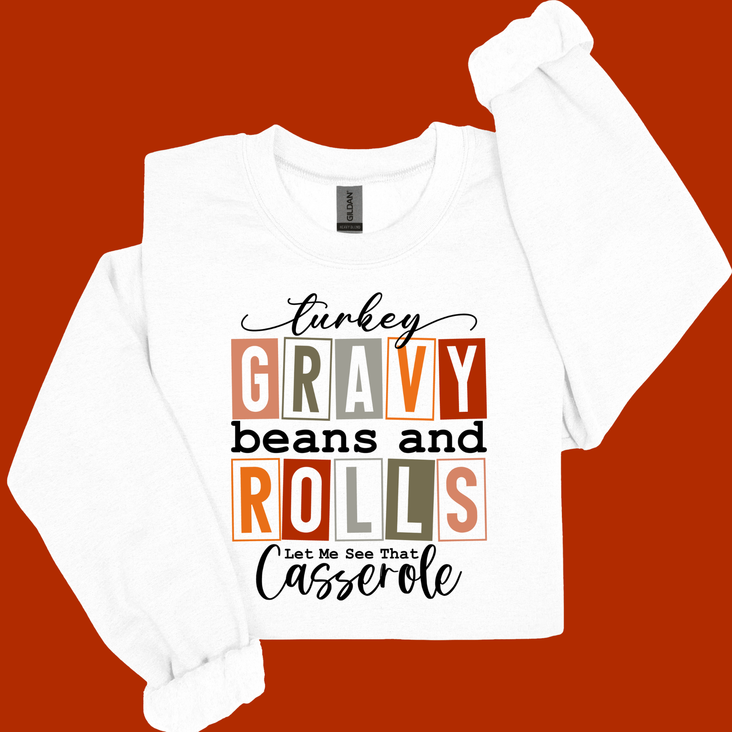 White long-sleeve shirt with colorful text design on a red background