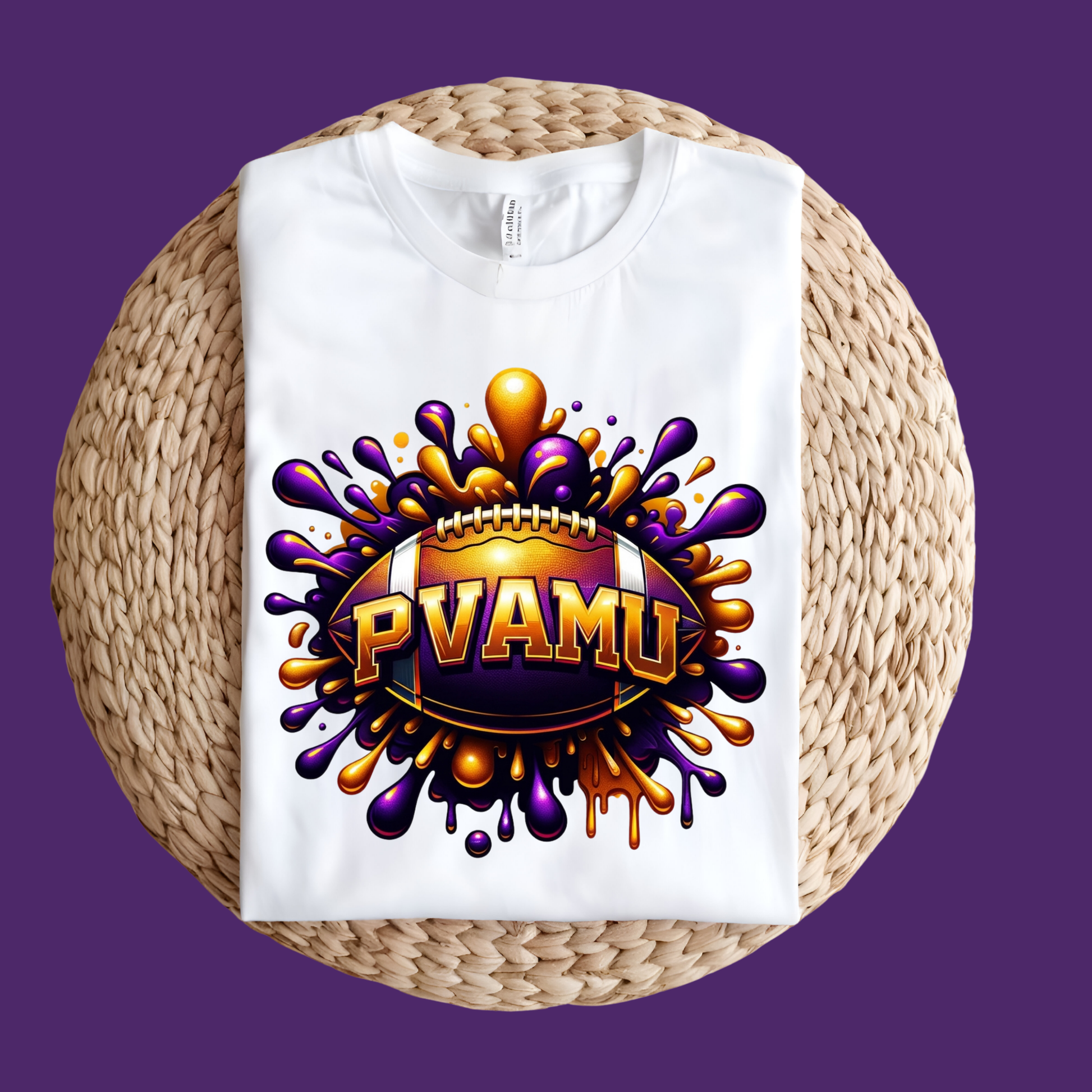 A white short-sleeve T-shirt laid flat on a round woven straw mat, featuring a large graphic of a purple and gold football player with the text 'PRAIRIE VIEW A&M PANTHERS' on the front, set against a solid purple background.