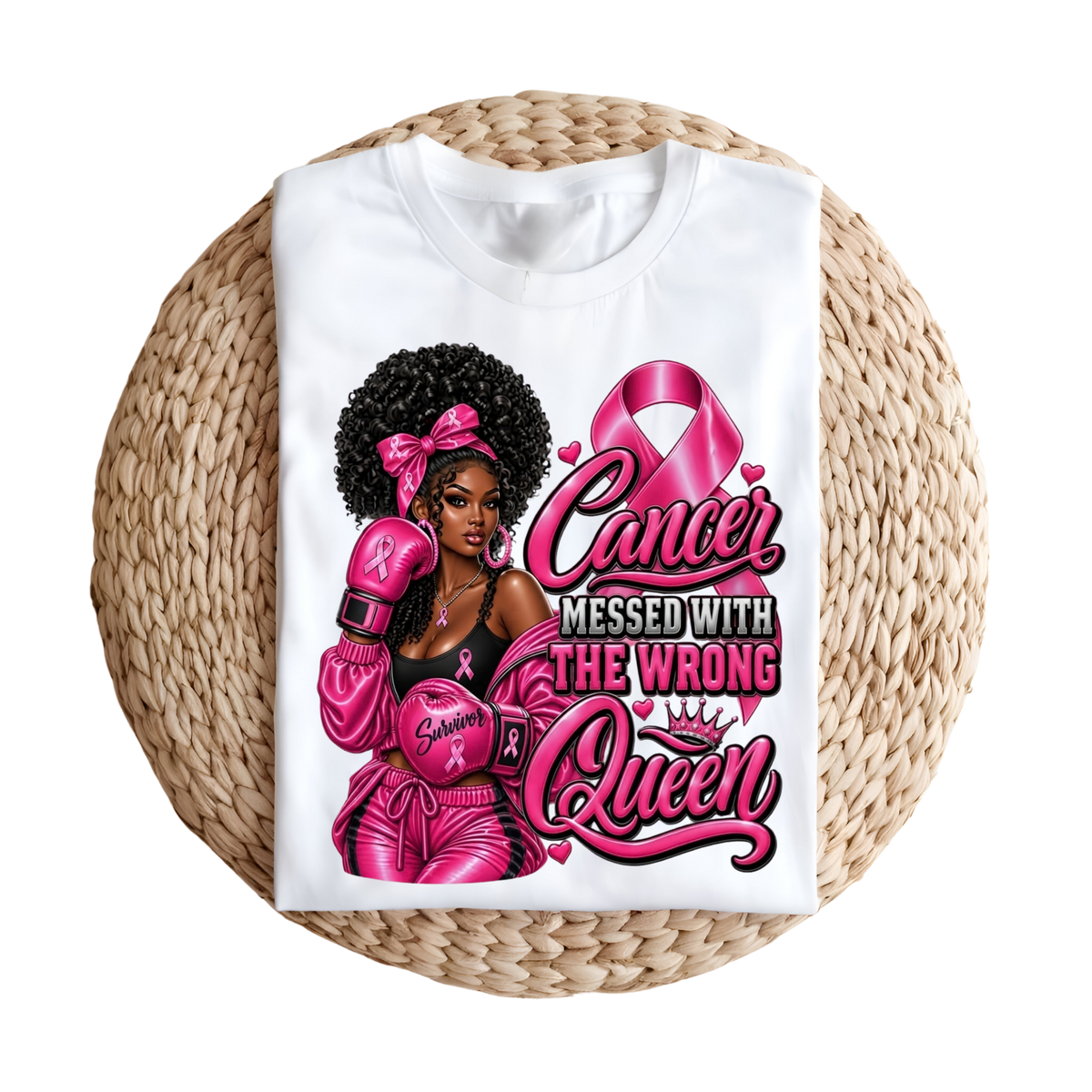 A folded white graphic T-shirt displayed on a round woven straw mat against a plain white background. The shirt features a large pink and black graphic with three illustrated women and the text 'HER Fight IS OUR Fight' with pink awareness ribbons.