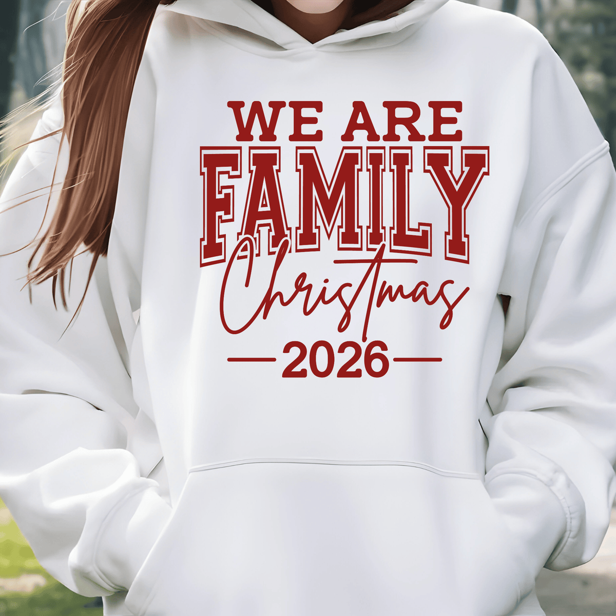 Set of five black matching family t-shirts printed with white 'We Are Family Christmas 2026' collegiate typography on a wooden backdrop.