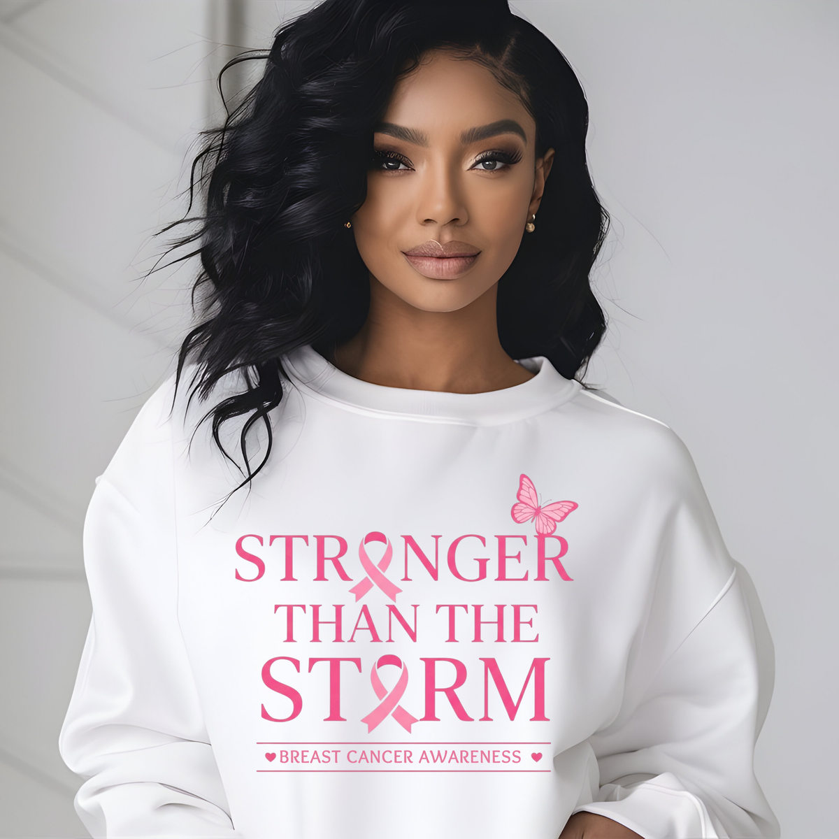 A woman wearing a white crewneck sweatshirt with a graphic print of a woman in a pink leopard-print hat and the text 'CRUSH Breast Cancer'.