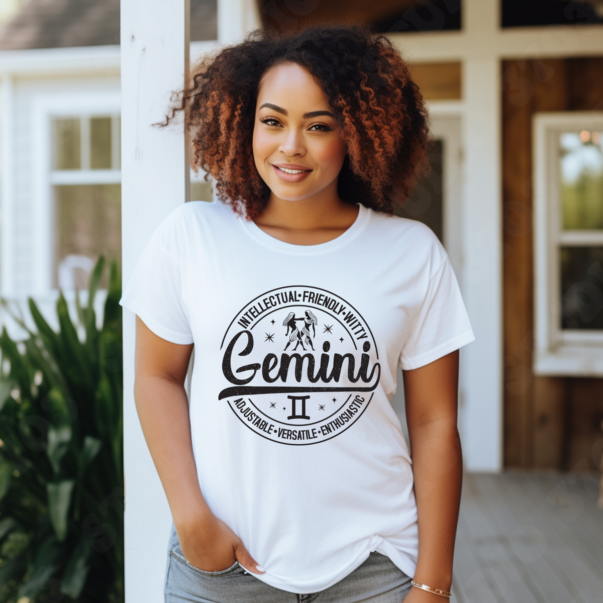white  t-shirt laid flat, featuring a circular white Gemini zodiac graphic with the twins illustration, the word "Gemini," and trait keywords like intellectual, friendly, witty, enthusiastic, versatile, and adjustable.