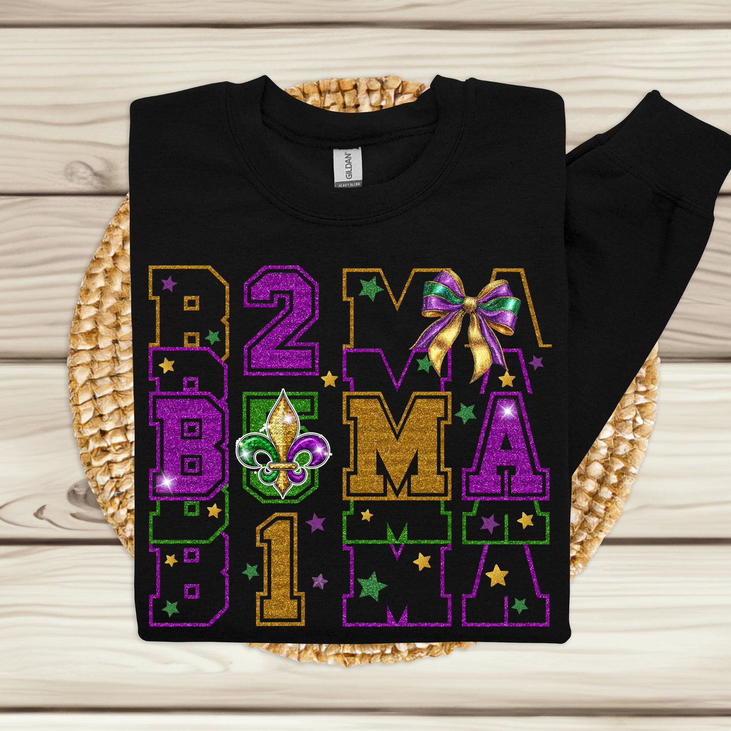 Black sweatshirt with colorful 'B2B Mardi Gras' design on a woven mat.