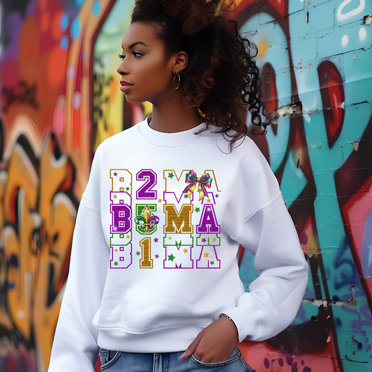 Person wearing a white sweatshirt with colorful text and graphics against a graffiti-covered wall.