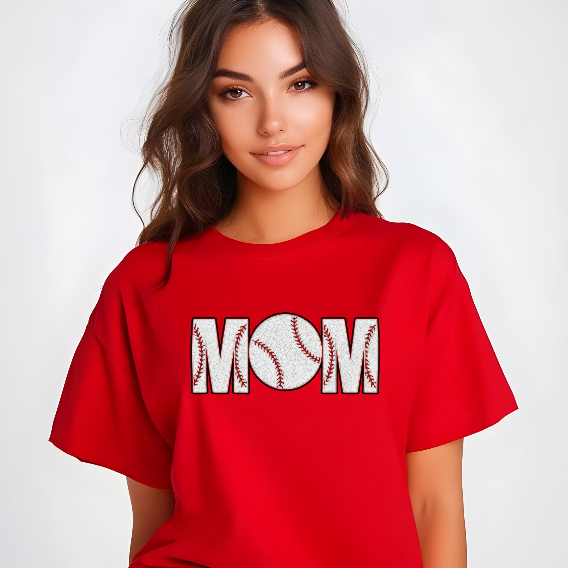 Woman wearing a red t-shirt with 'MOM' and a baseball graphic on a white background
