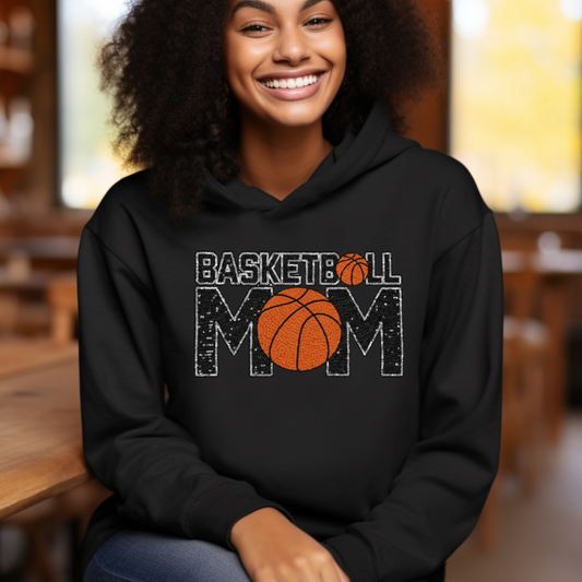 Person wearing a black hoodie with 'Basketball Mom' text and basketball graphic.