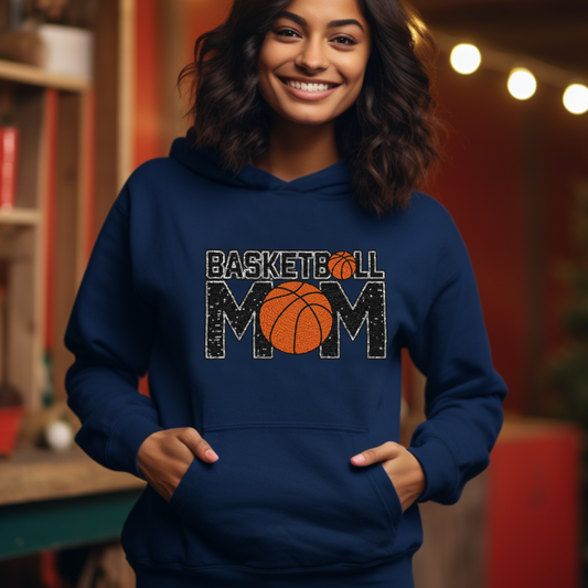Woman wearing a blue hoodie with 'Basketball Mom' text and basketball graphic.