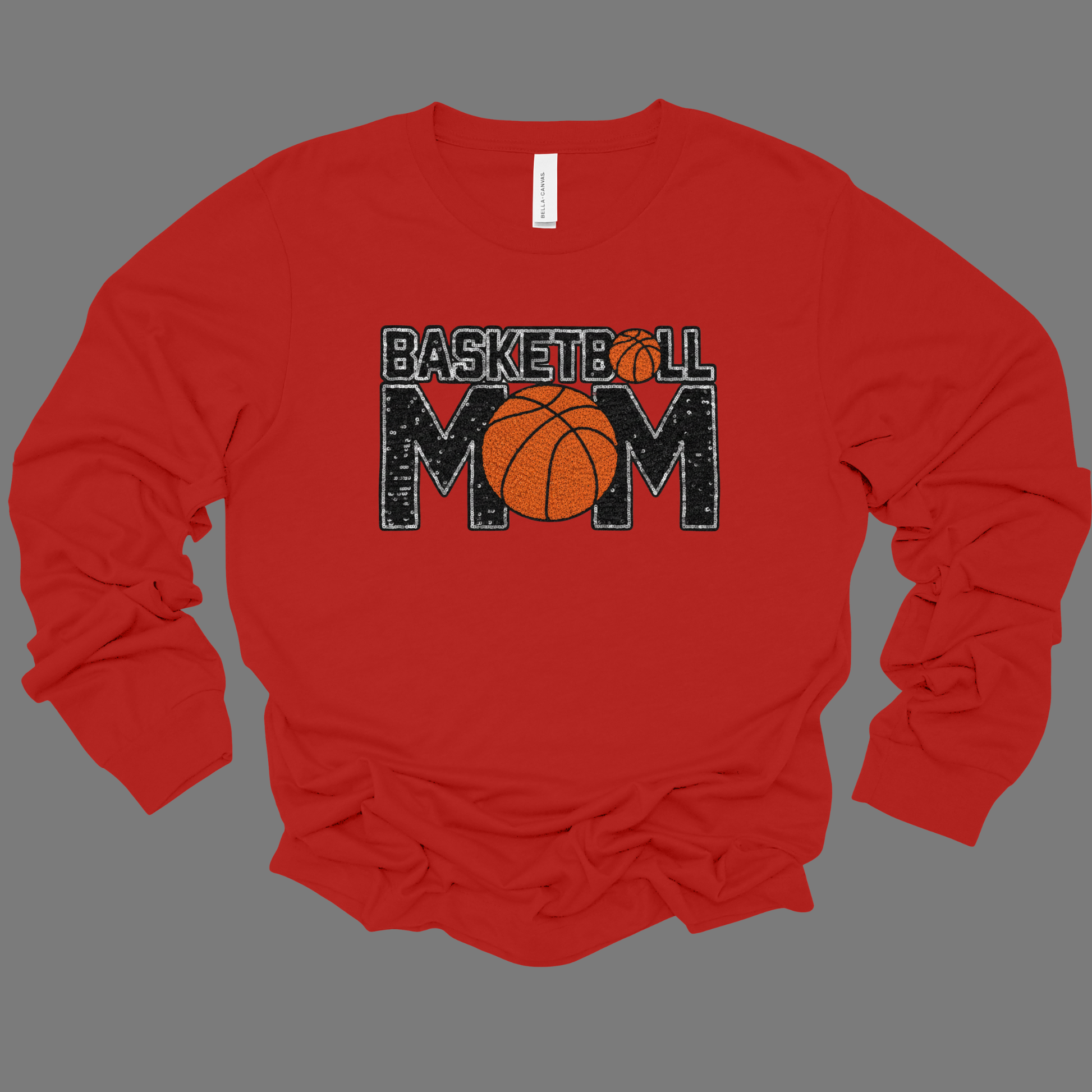 Red long-sleeve shirt with 'Basketball Mom' text and basketball graphic on a gray background