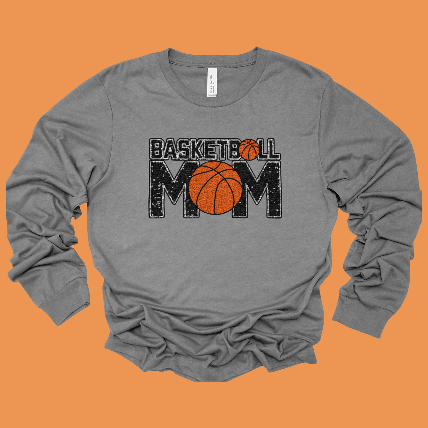 Gray long-sleeve shirt with 'Basketball Mom' text and basketball graphic on an orange background