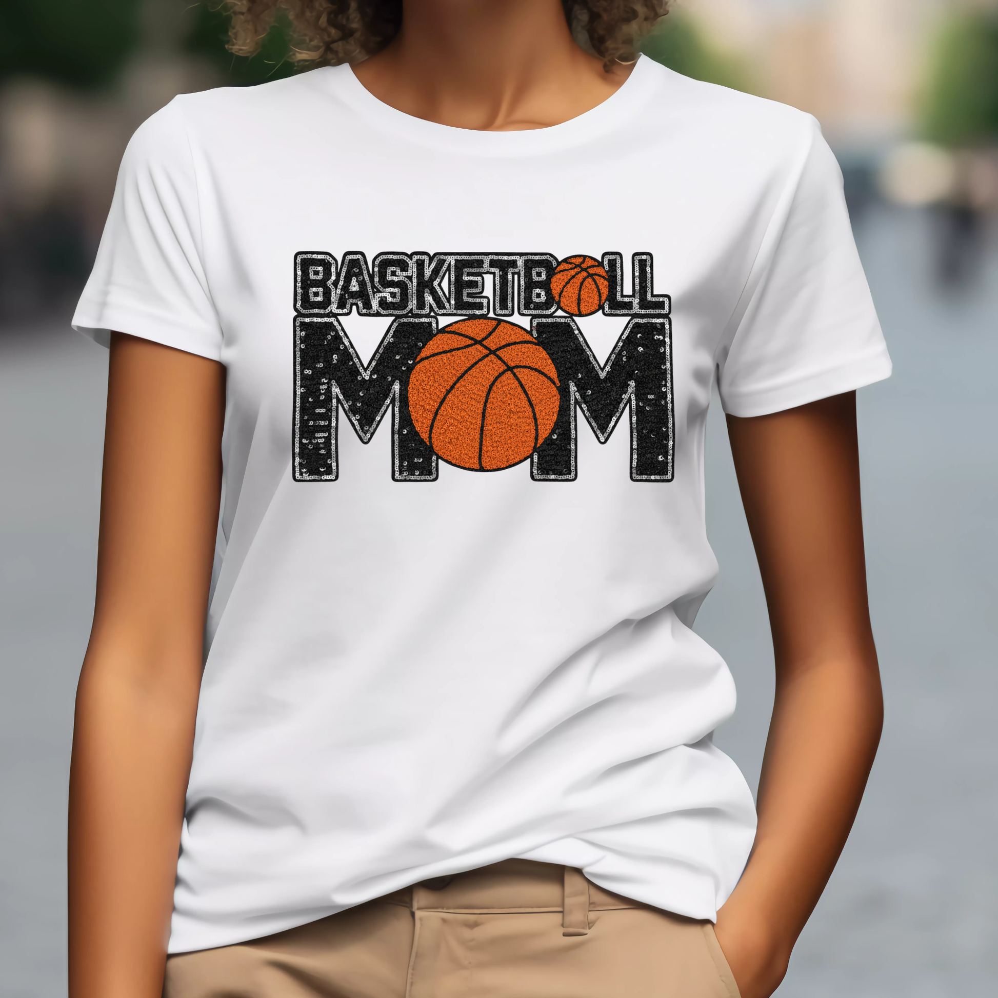 Person wearing a white t-shirt with 'Basketball Mom' design.