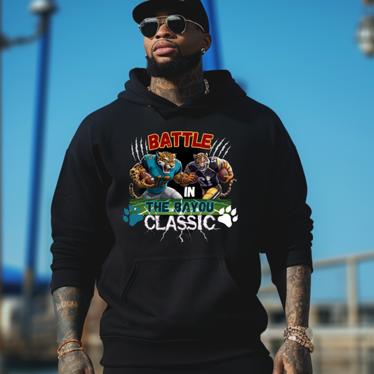 Person wearing a black hoodie with 'Battle in the Bayou Classic' graphic against a blue sky.  Bayou Classic Hoodie: Battle in the Bayou Classic Game Day Unisex Hoodie
