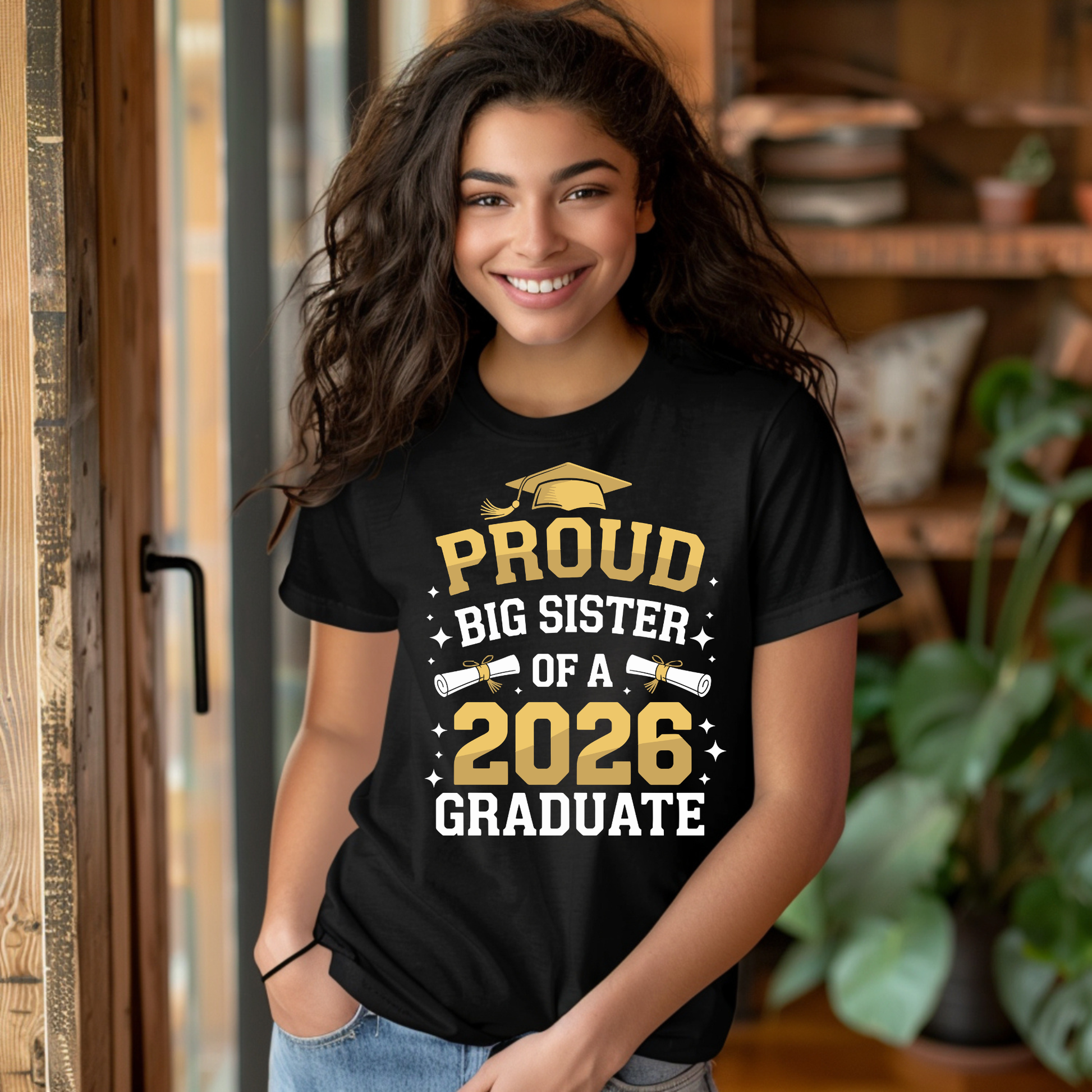 Person wearing a black t-shirt with 'Proud Big Sister of a 2026 Graduate' text.