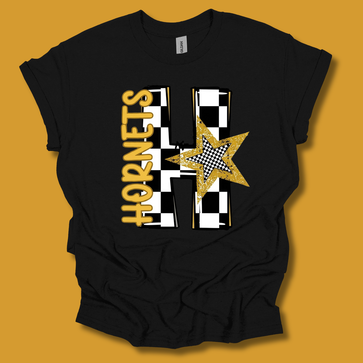 A black short-sleeve t-shirt with a graphic print reading 'IT'S ALABAMA STATE UNIVERSITY FOR ME! 1867' in gold and white, featuring the Alabama State Hornets mascot, displayed against a solid mustard yellow background.