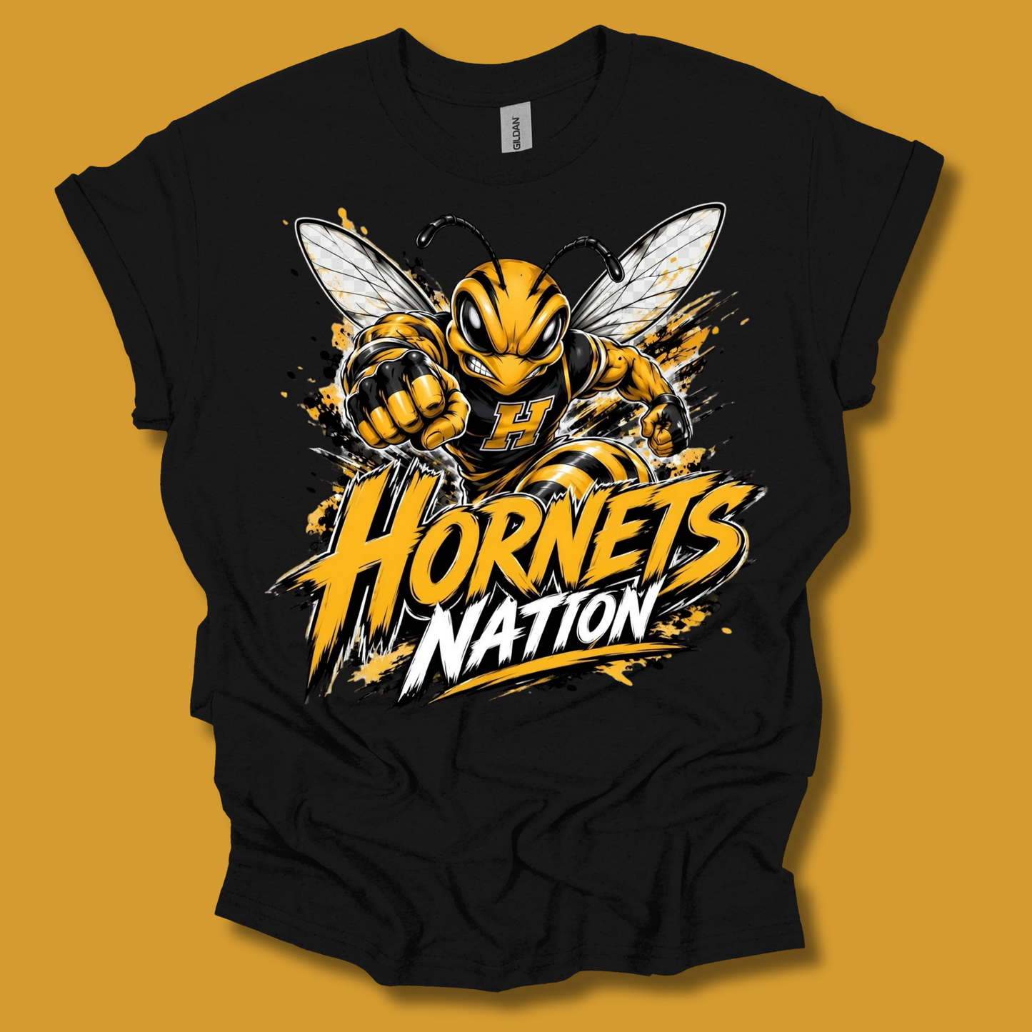 A black short-sleeve t-shirt with a large graphic of a yellow and black hornet and the text 'Hornets Nation' in yellow, white, and black, displayed against a solid mustard yellow background.